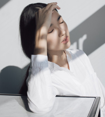 woman leaning on white table photo