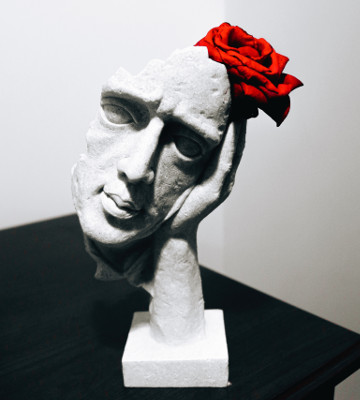 grey ceramic woman's face with red rose figurine